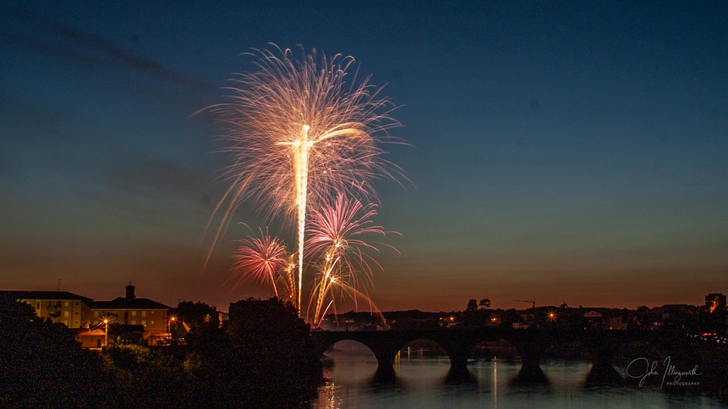 Firework exploding against a darkened sky