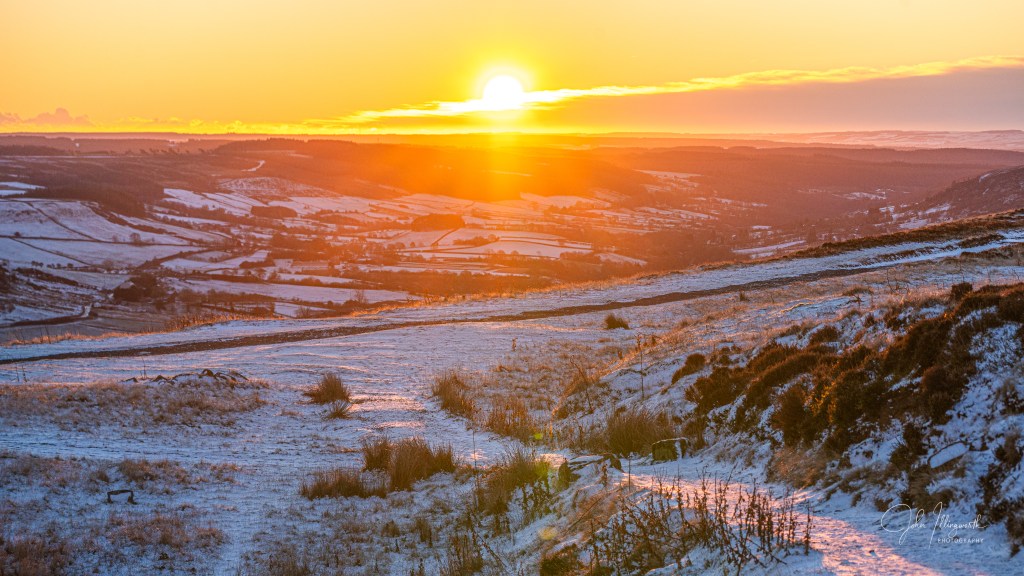 sun shining low on a frosty landscape